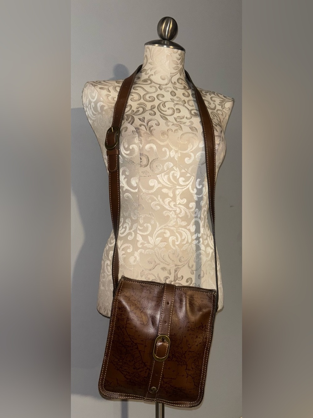 Patricia Nash Venezia Crossbody Pouch in a brown leather map print.